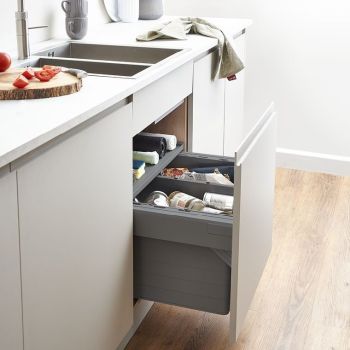 Blum Tandembox Ninka 600mm under-sink kitchen bin with 2 compartments  soft-close pull-out drawers  storing waste and recyclables  installed in white cabinet with granite countertop.