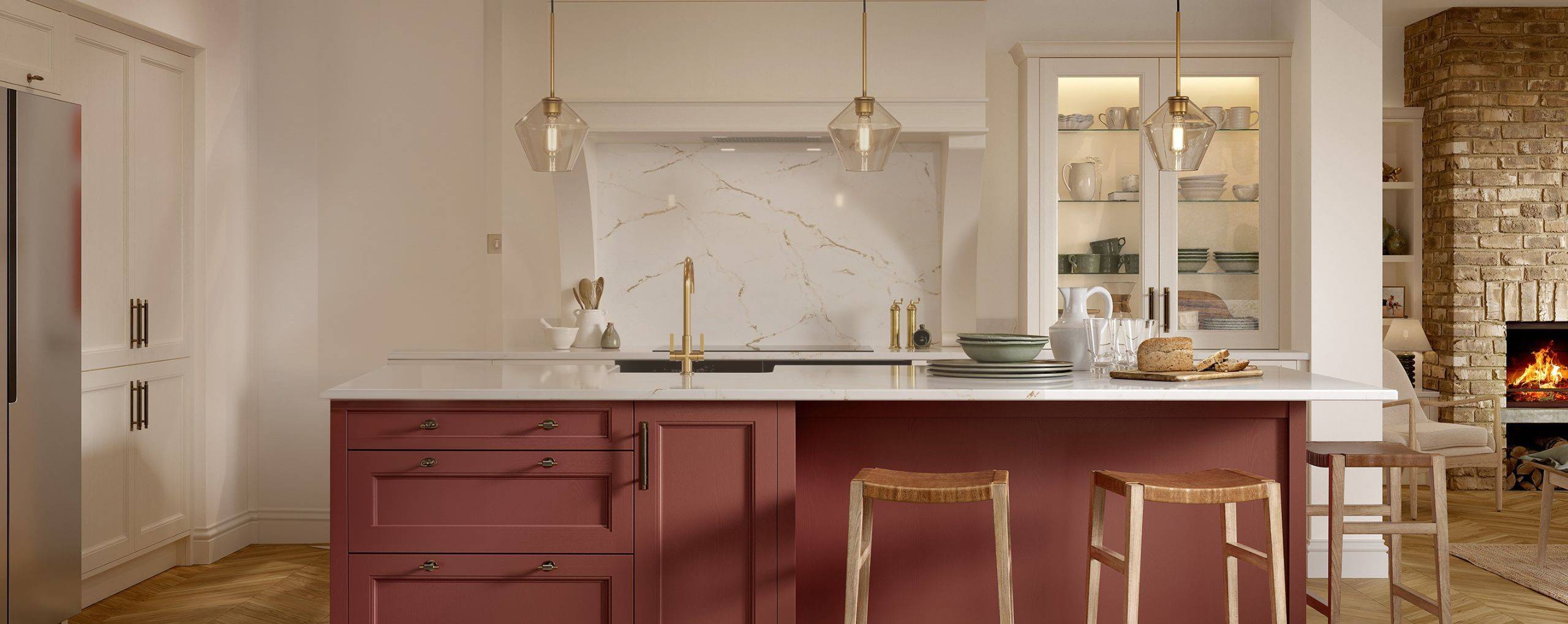 A bright, premium Kitchenfair kitchen with an antique-red island, marble splashback and brass fittings